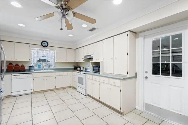 a kitchen with cabinets and window