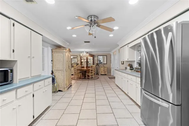 a kitchen with stainless steel appliances a refrigerator sink and cabinets