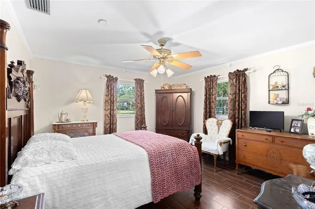 a spacious bedroom with a bed dresser and a window