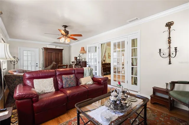a living room with furniture a flat screen tv and a table
