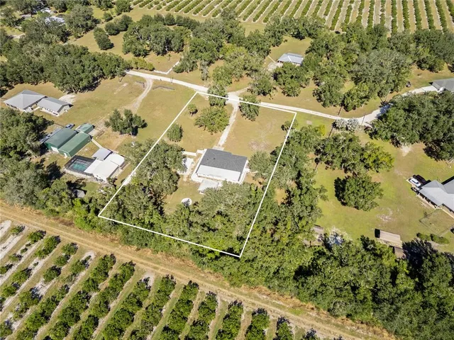 an aerial view of a residential houses with outdoor space