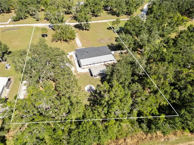 an aerial view of ocean with residential house and outdoor space