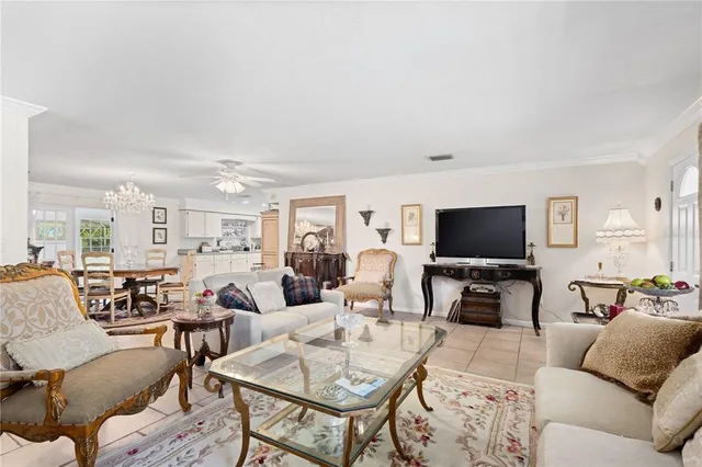 a living room with furniture a flat screen tv and a large window