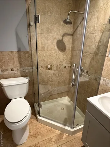 a bathroom with a toilet and a shower