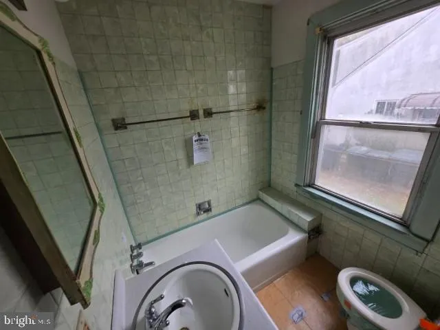 a bathroom with a sink and glass door