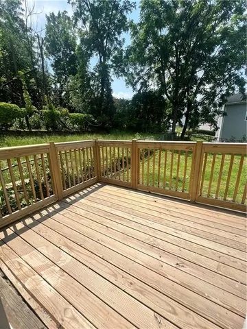 a view of balcony with wooden floor and fence