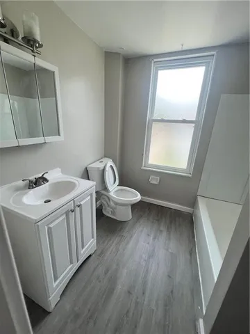 a view of a bathroom with a sink a toilet and a window