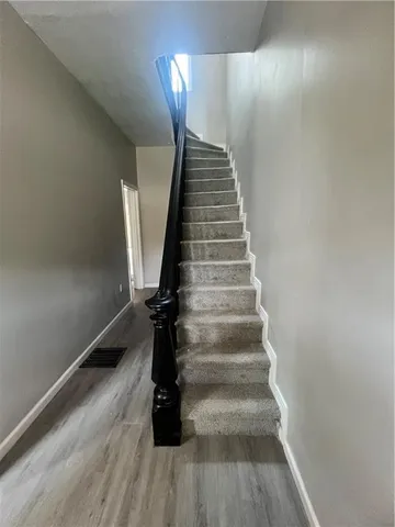 a view of entryway and hall with wooden floor