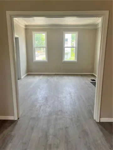 an empty room with windows and closet