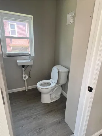 a white toilet sitting next to a window