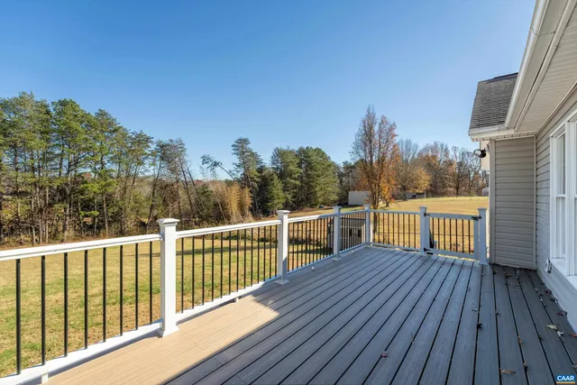 a view of a balcony with wooden floor and fence