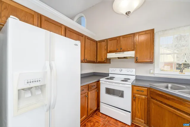 a kitchen with a white cabinets and white appliances