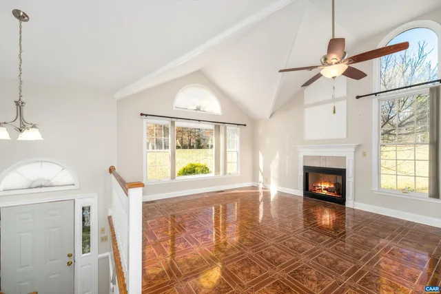 a view of an empty room with a fireplace and a window