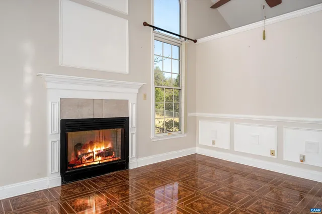 a view of an empty room with a fireplace and a window