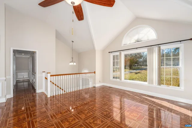 a view of a room with wooden floor and windows