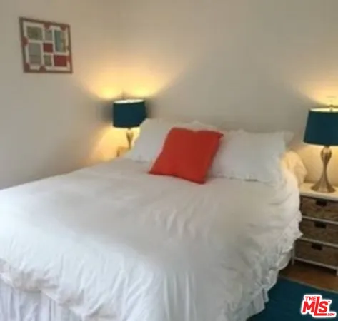 a bedroom with a bed and lamp