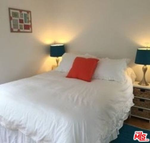 a bedroom with a bed and lamp