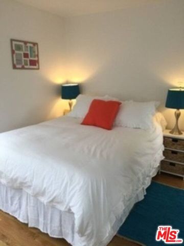 a bedroom with a bed and a night stand