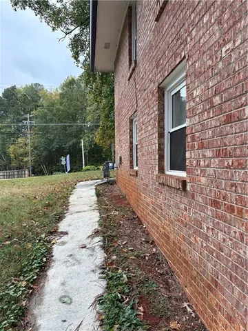 a view of a kitchen with a refrigerator and a window