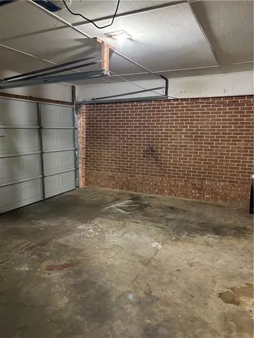 an empty room with chandelier fan and windows