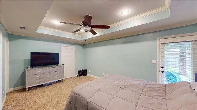 a bedroom with a bed and a flat tv screen on dresser
