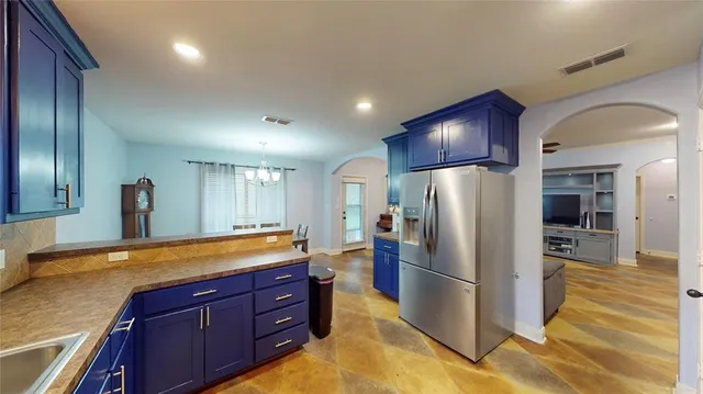 a kitchen with stainless steel appliances granite countertop a refrigerator and a sink