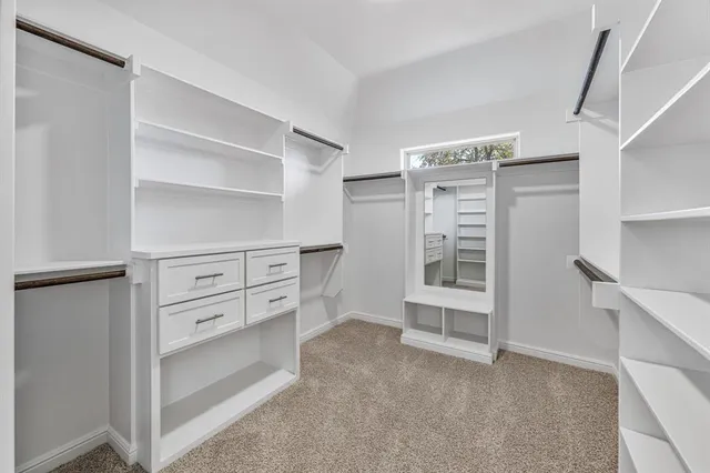 a view of cabinets and utility room with closet