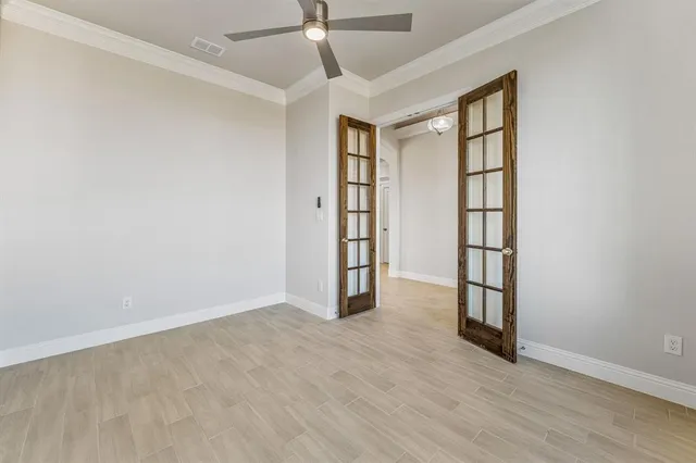 an empty room with windows and closet