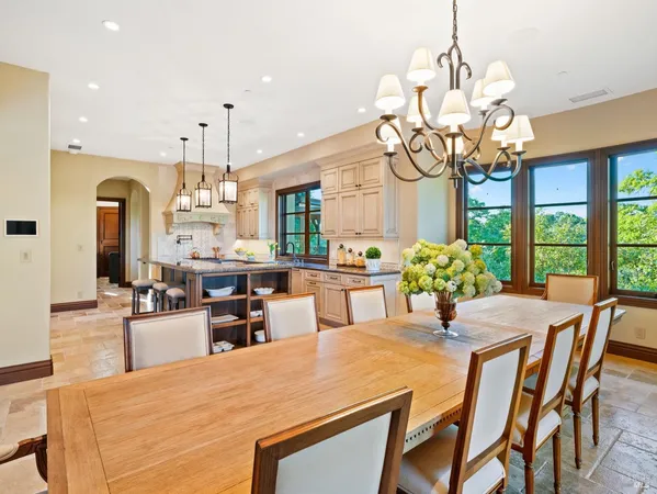 a view of a livingroom with wooden floor kitchen cabinet and windows