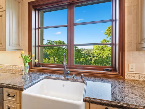 a kitchen with stainless steel appliances granite countertop a sink and cabinets