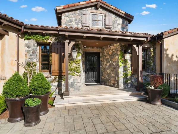 a view of a house with potted plants