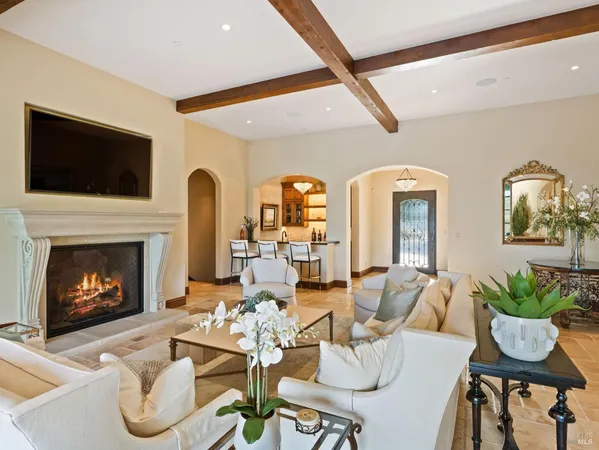 a dining room with chandelier fan and wooden floor