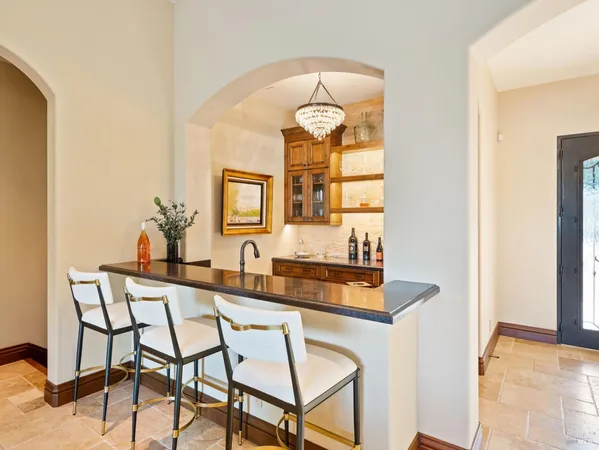 a kitchen with stainless steel appliances wooden floor dining table and chairs