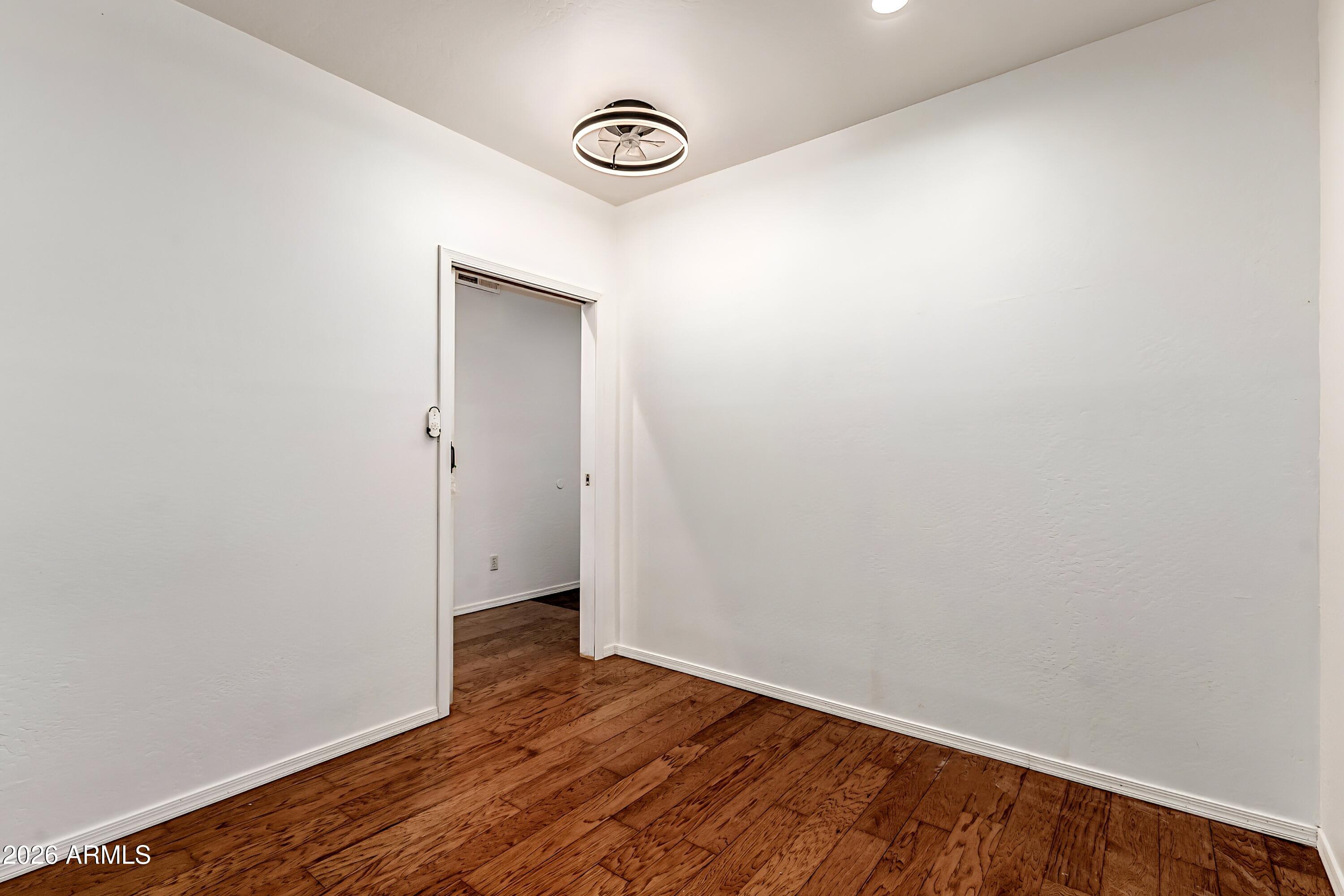 4208 South Sawmill Road Gilbert, AZ 85297 - Photo 35 of 46 a view of an empty room with wooden floor