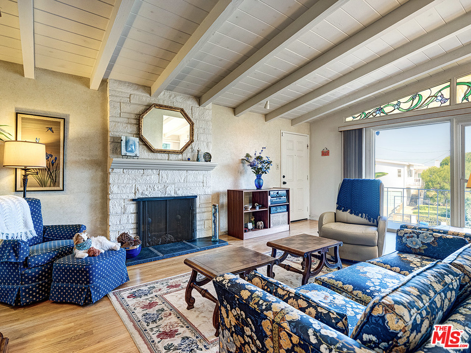 7553 Trask Avenue Playa del Rey, CA 90293 - Photo 2 of 24 a living room with furniture a fireplace and a large window