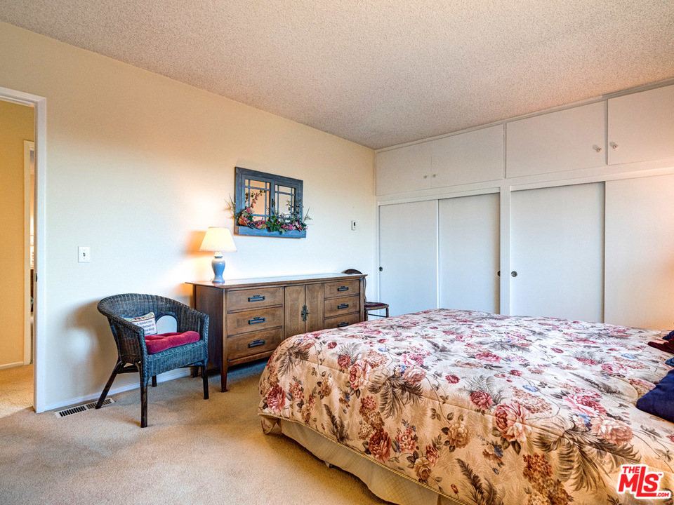 7553 Trask Avenue Playa del Rey, CA 90293 - Photo 16 of 24 a bedroom with a bed and a chair