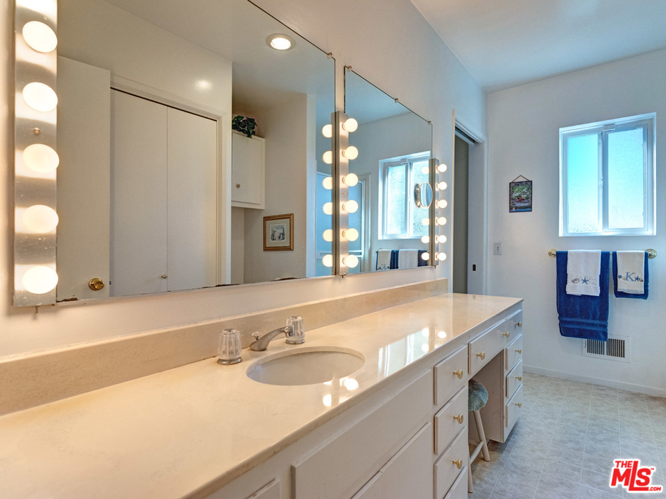 7553 Trask Avenue Playa del Rey, CA 90293 - Photo 17 of 24 a bathroom with a granite countertop sink and a mirror