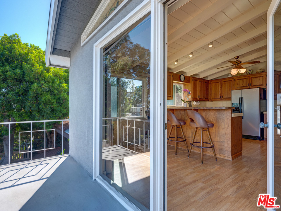 7553 Trask Avenue Playa del Rey, CA 90293 - Photo 5 of 24 a view of a porch with chairs and floor to ceiling window