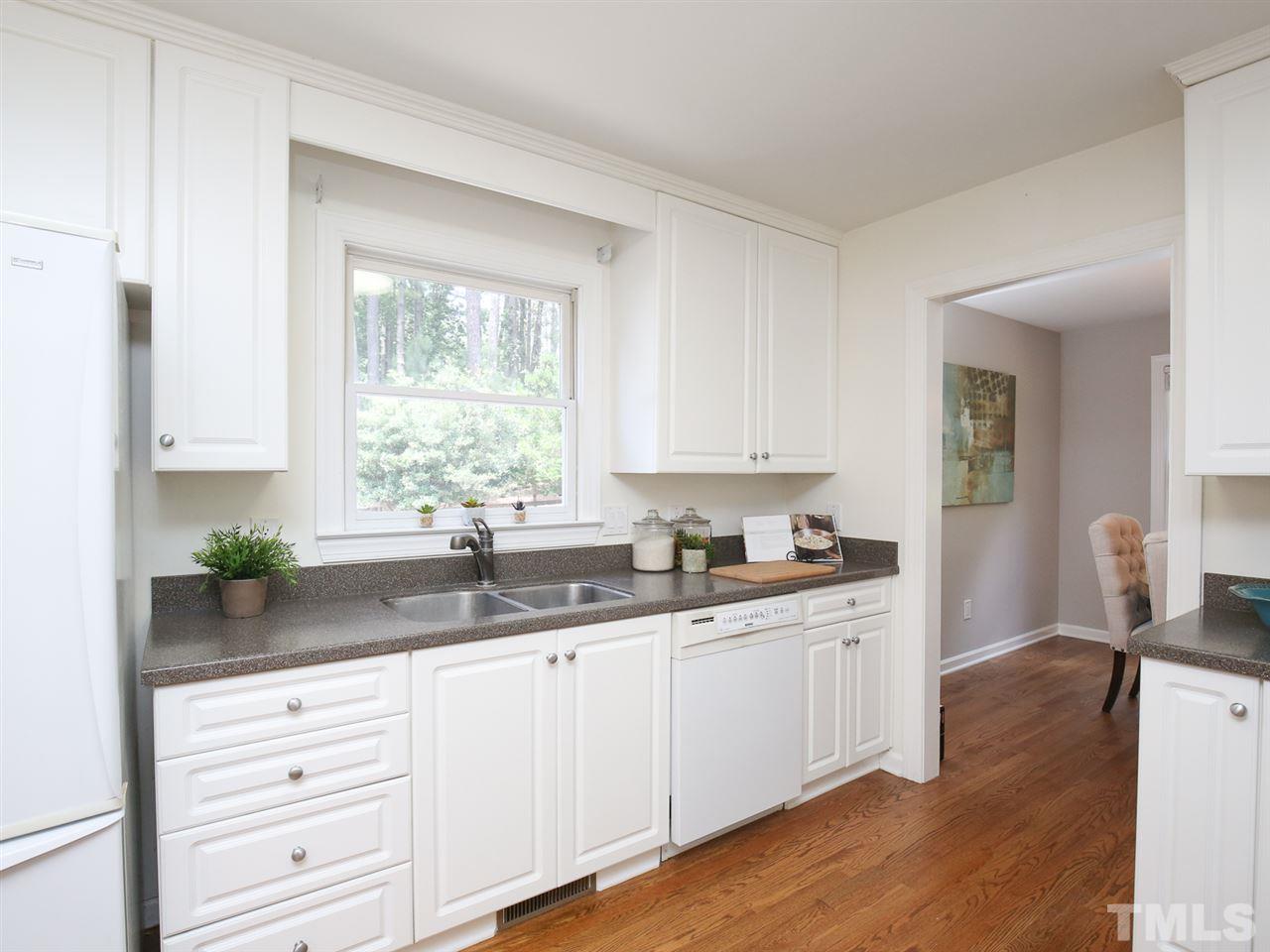1829 Mt Vernon Church Road Raleigh, NC 27614 - Photo 12 of 30 a kitchen with granite countertop white cabinets and white appliances