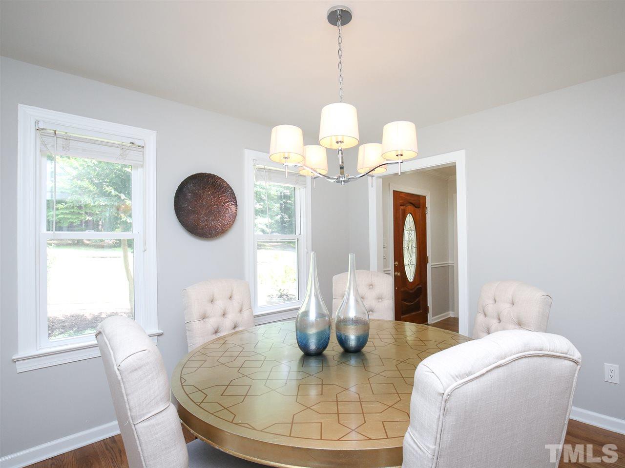 1829 Mt Vernon Church Road Raleigh, NC 27614 - Photo 5 of 30 a view of a dining room with furniture a chandelier and wooden floor