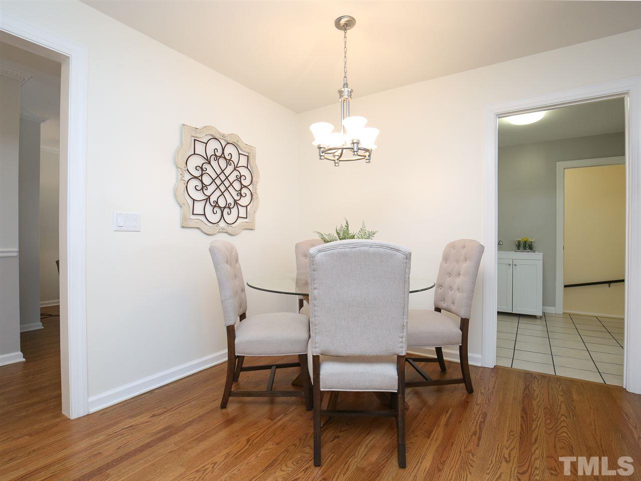 1829 Mt Vernon Church Road Raleigh, NC 27614 - Photo 10 of 30 a view of a dining room with furniture wooden floor and a chandelier