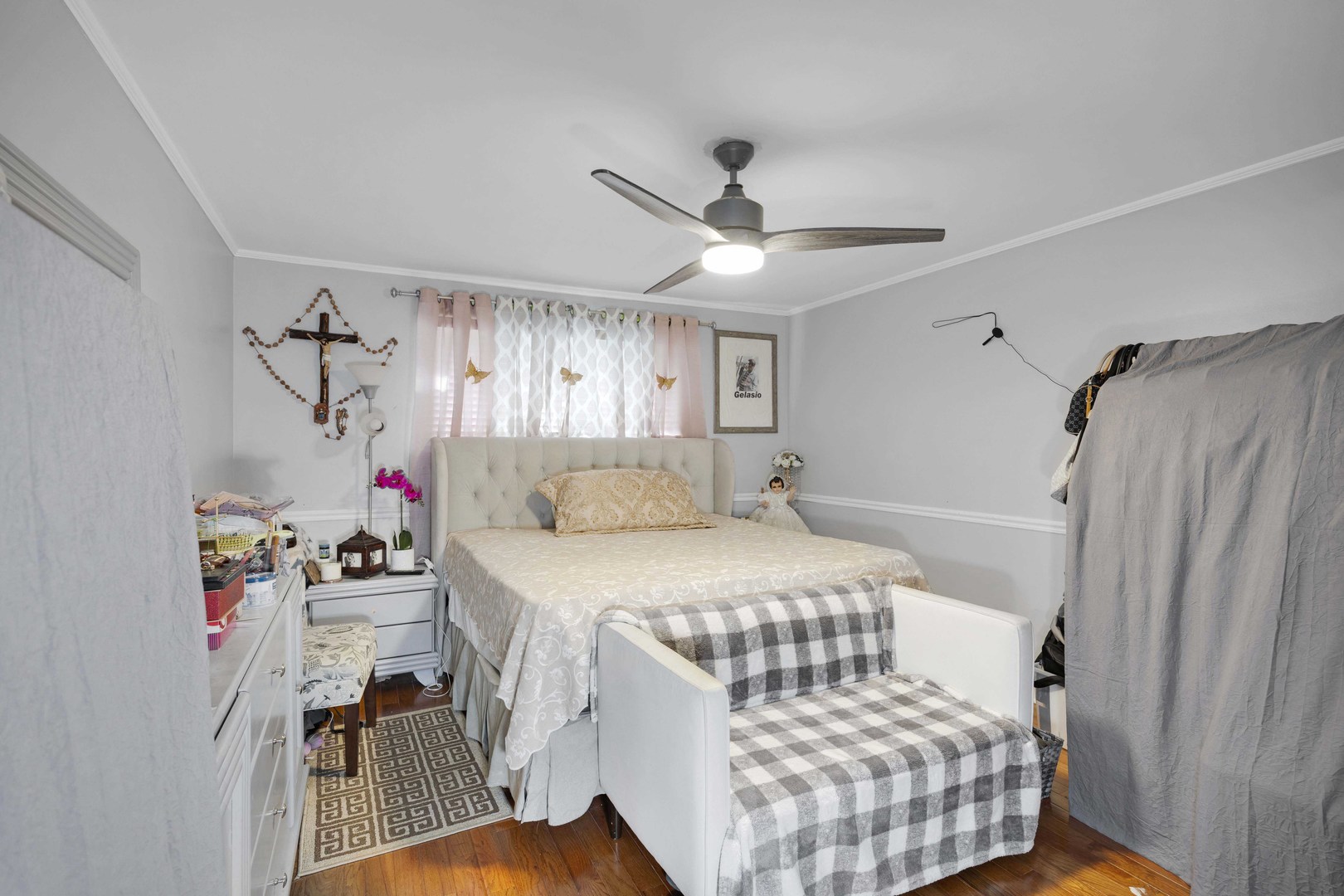 1943 182nd Street Lansing, IL 60438 - Photo 11 of 17 a bedroom with a bed and a chandelier