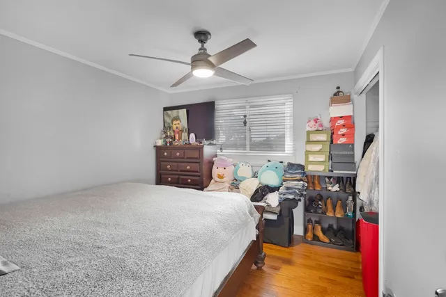 a bed room with a bed window and a ceiling fan