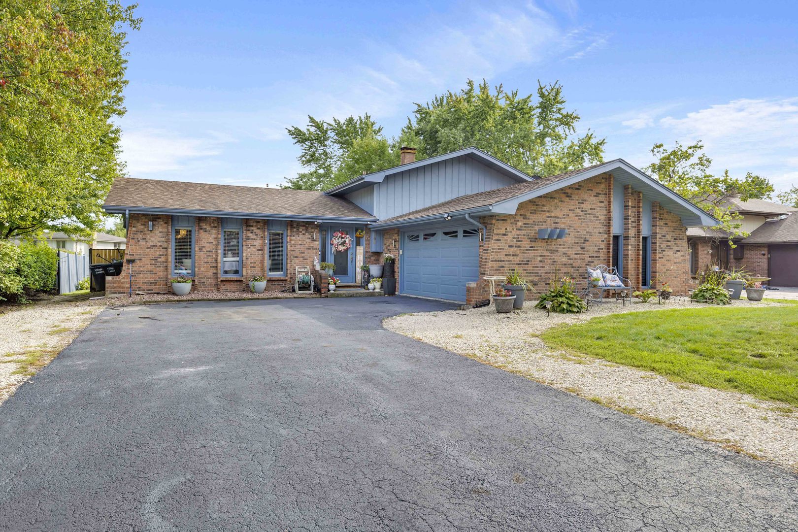 1943 182nd Street Lansing, IL 60438 - Photo 17 of 17 a view of a house with a yard and potted plants