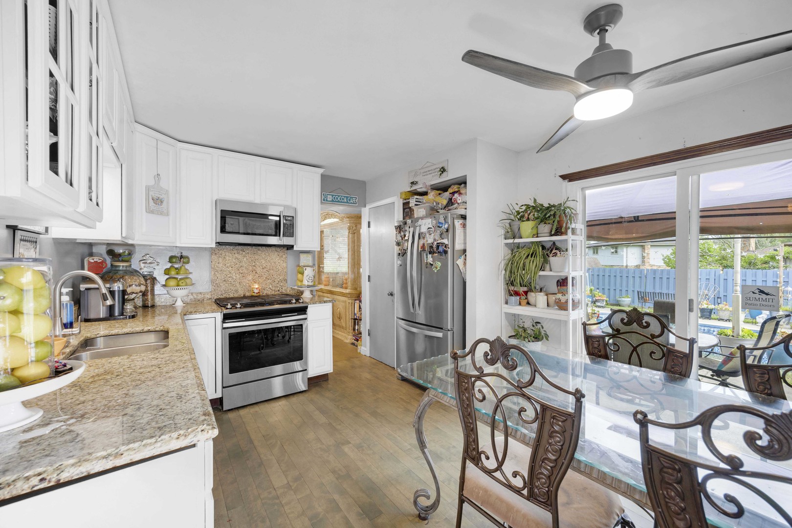1943 182nd Street Lansing, IL 60438 - Photo 7 of 17 a kitchen with granite countertop a stove a sink a refrigerator and a dining table