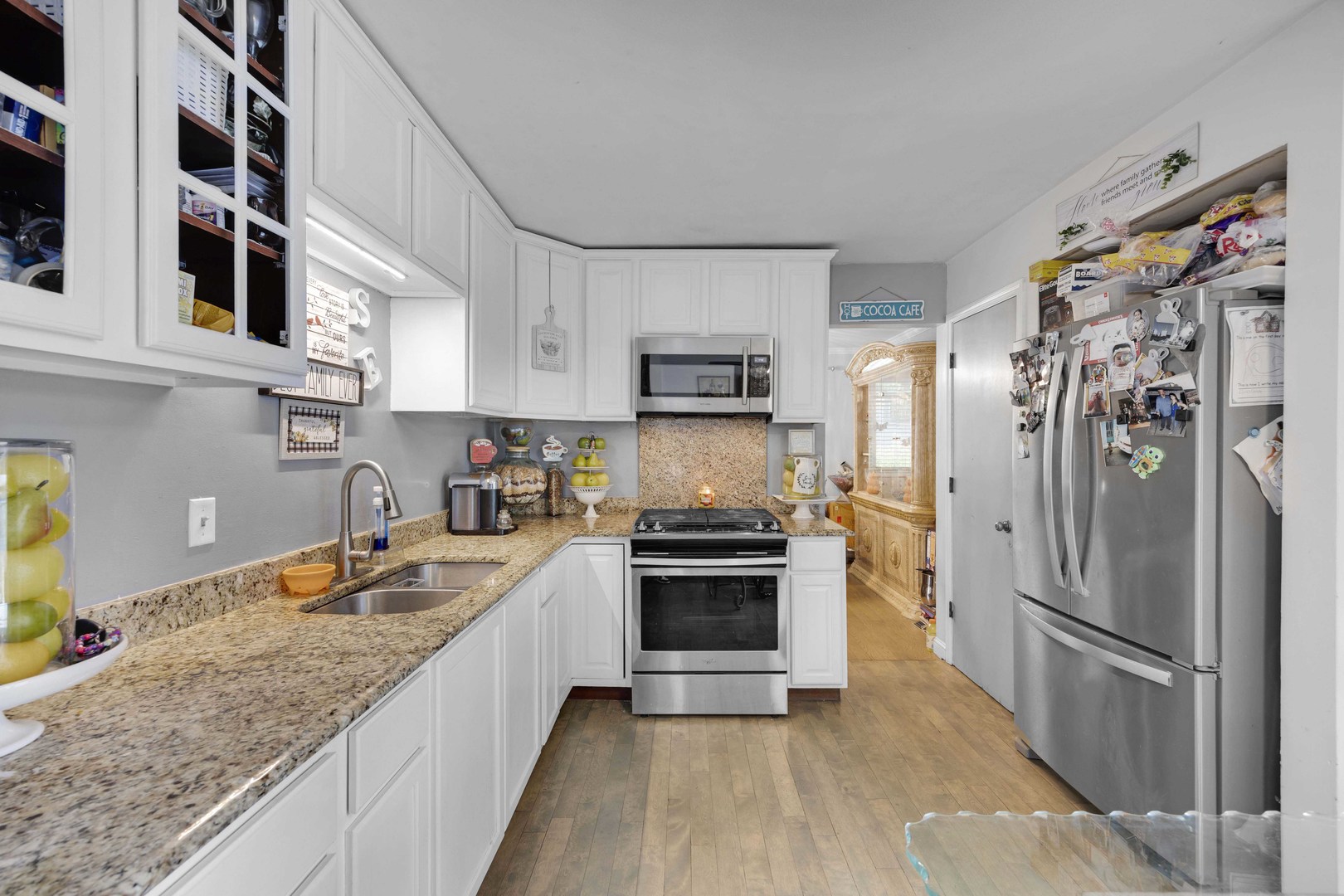1943 182nd Street Lansing, IL 60438 - Photo 8 of 17 a kitchen with stainless steel appliances granite countertop a refrigerator a stove a sink and a microwave