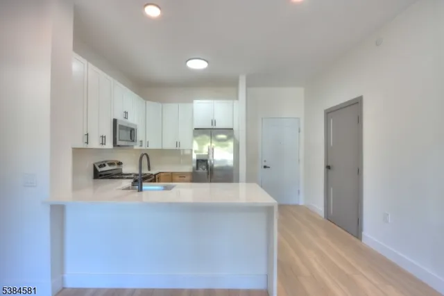 a view of kitchen with wooden floor