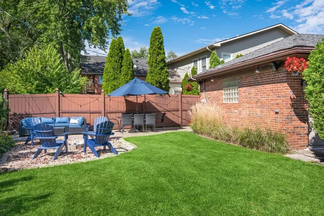 a backyard of a house with table and chairs