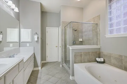a bathroom with a tub sink and mirror