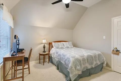 a bedroom with a bed and a table in it